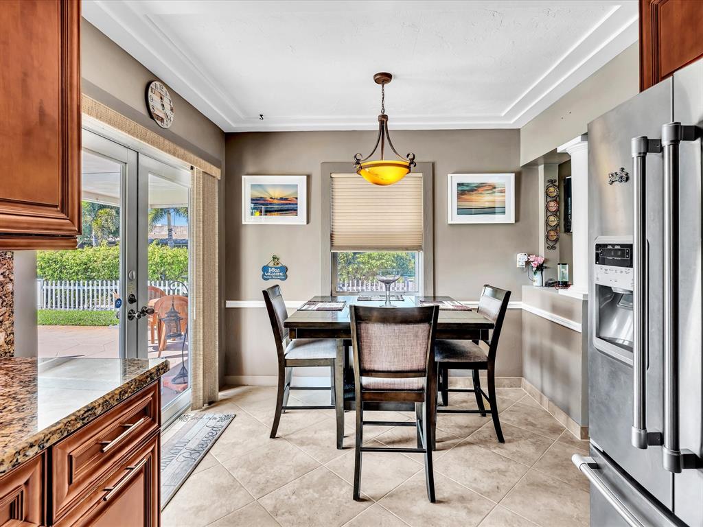 5180 Southwest 13th Street Plantation, FL 33317 - Photo 19 of 54 a view of a dining room with furniture and a window