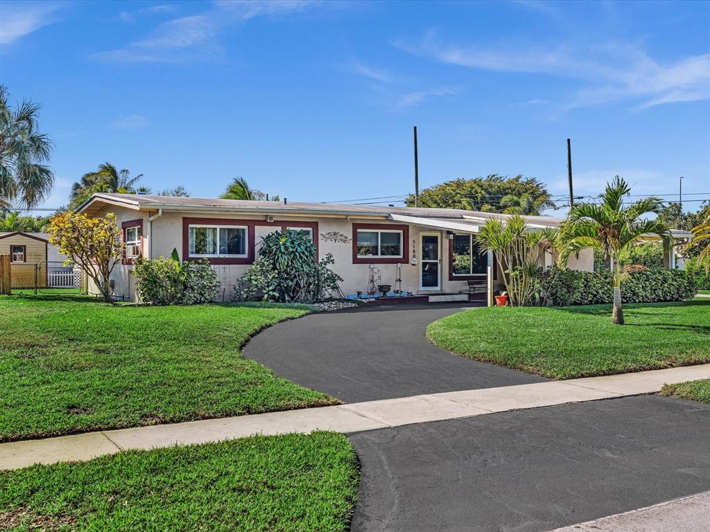 5180 Southwest 13th Street Plantation, FL 33317 - Photo 2 of 54 a view of a house with a yard and potted plants
