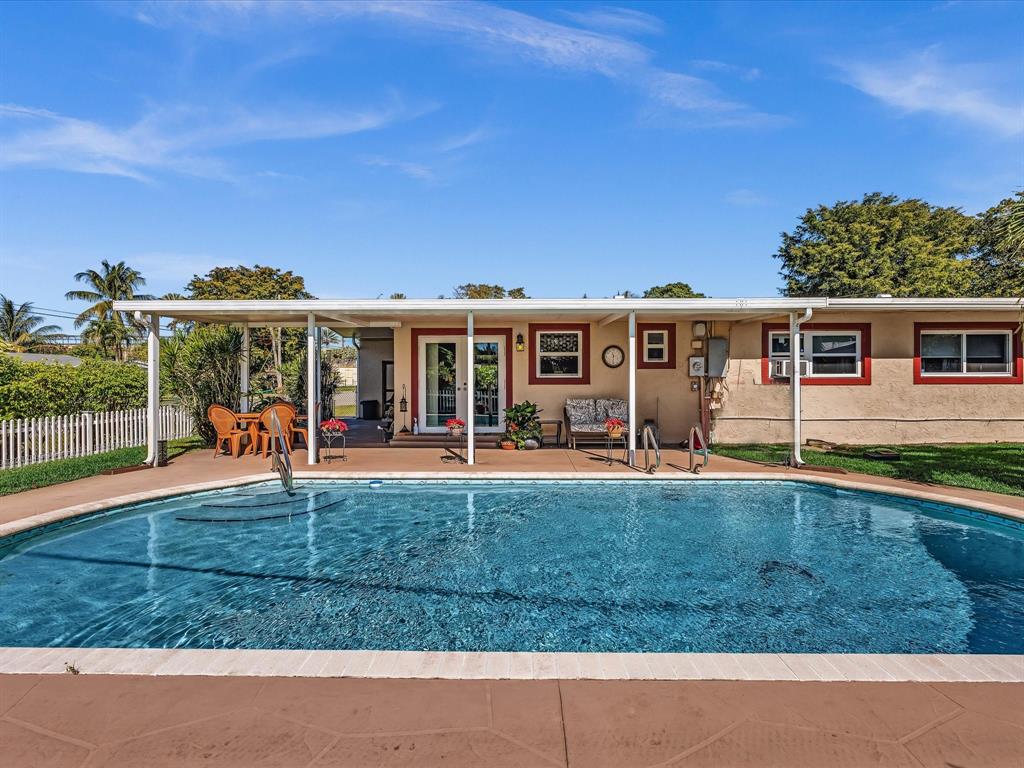 5180 Southwest 13th Street Plantation, FL 33317 - Photo 37 of 54 a view of a house with a backyard porch and sitting area