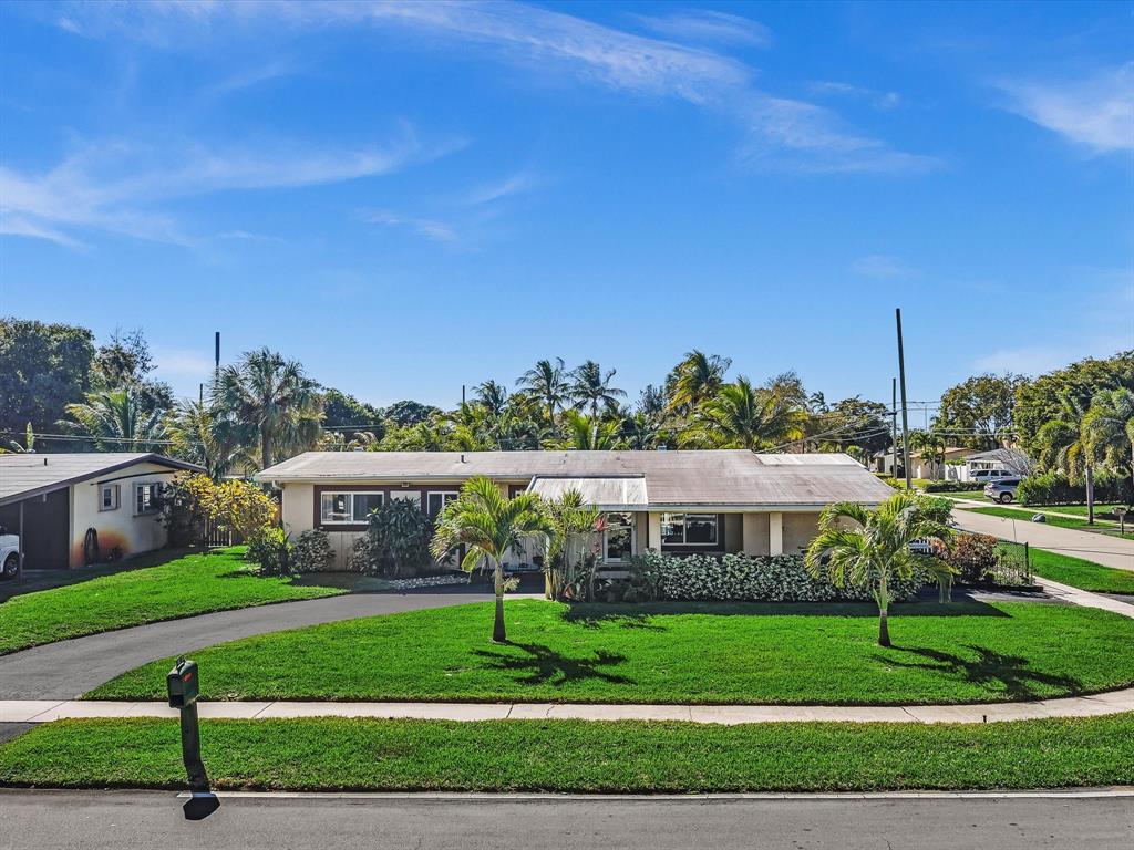5180 Southwest 13th Street Plantation, FL 33317 - Photo 40 of 54 a front view of a house with a yard