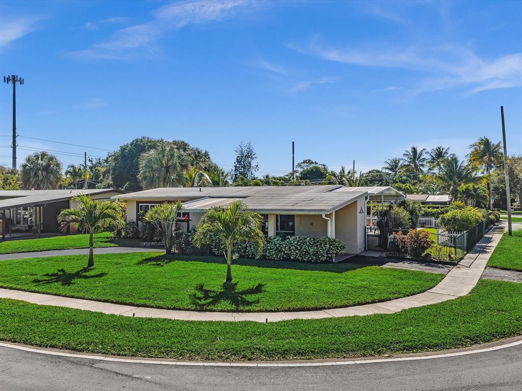 5180 Southwest 13th Street Plantation, FL 33317 - Photo 51 of 54 a front view of a house with a yard