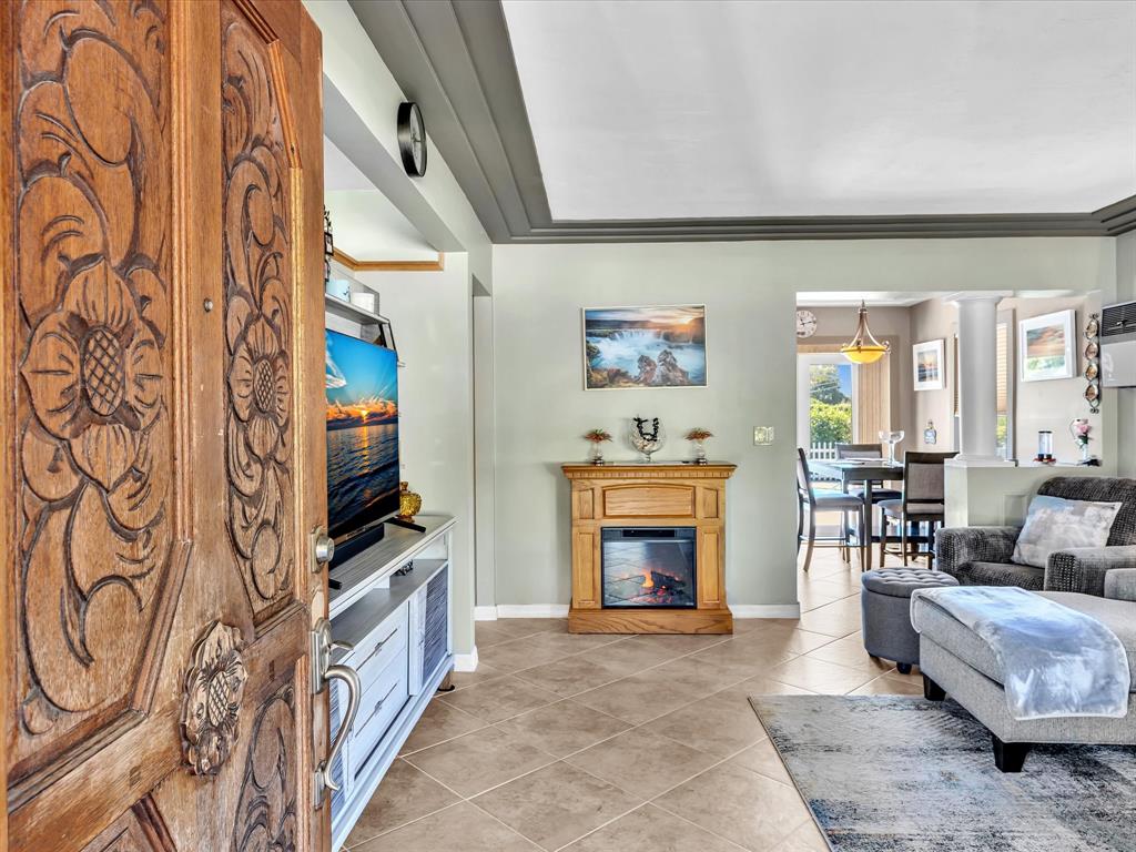 5180 Southwest 13th Street Plantation, FL 33317 - Photo 7 of 54 a living room with furniture a fireplace and a flat screen tv