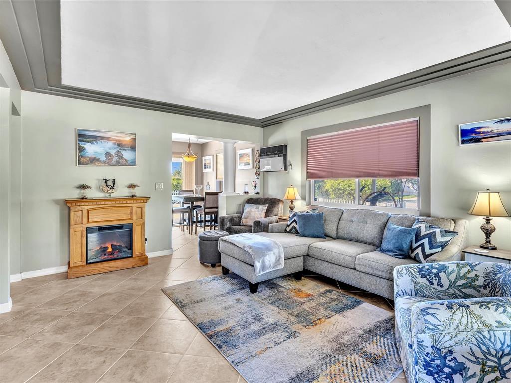 5180 Southwest 13th Street Plantation, FL 33317 - Photo 8 of 54 a living room with furniture a fireplace and a flat screen tv