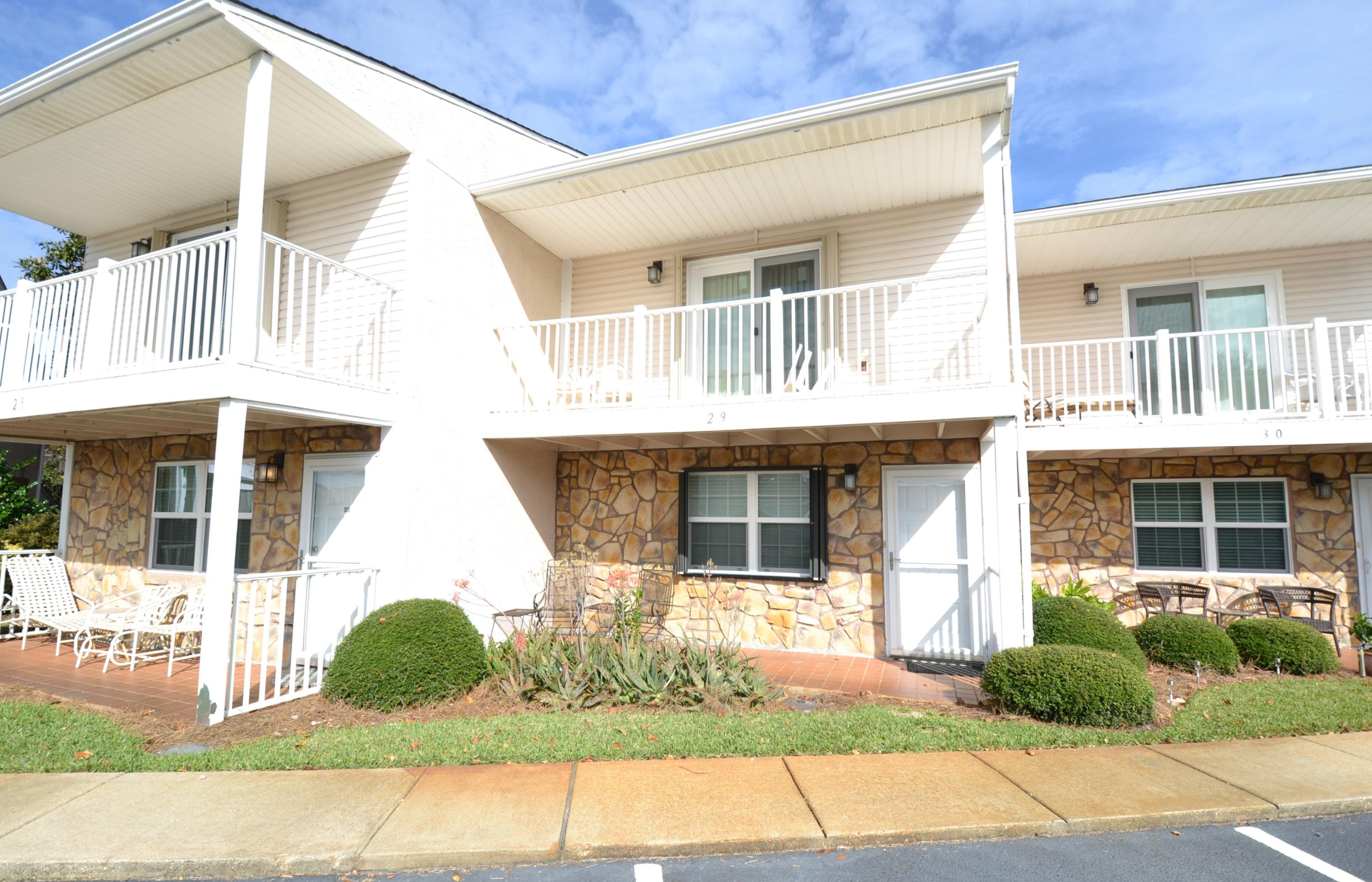 241 Ellis Road, Unit 29 Miramar Beach, FL 32550 - Photo 1 of 19 a front view of a house with a garden