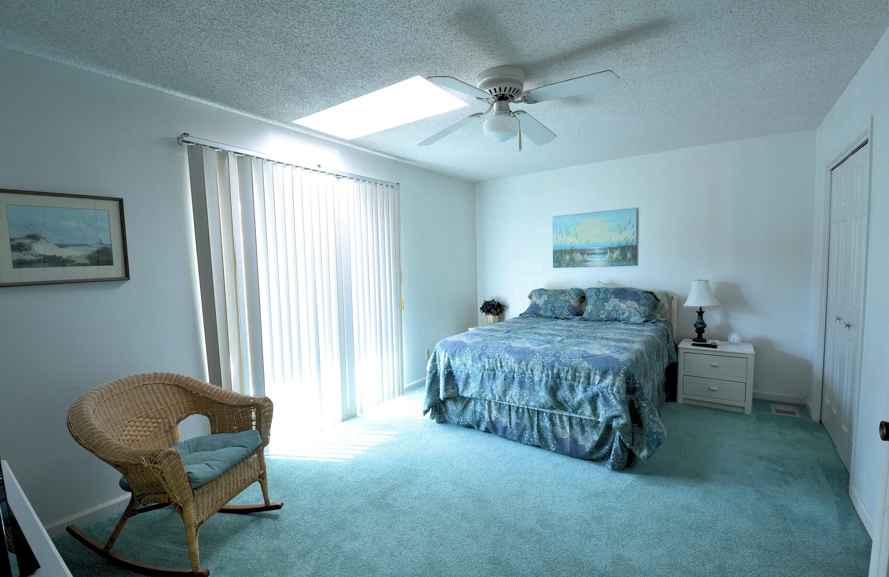 241 Ellis Road, Unit 29 Miramar Beach, FL 32550 - Photo 11 of 19 a bedroom with a bed and a chair