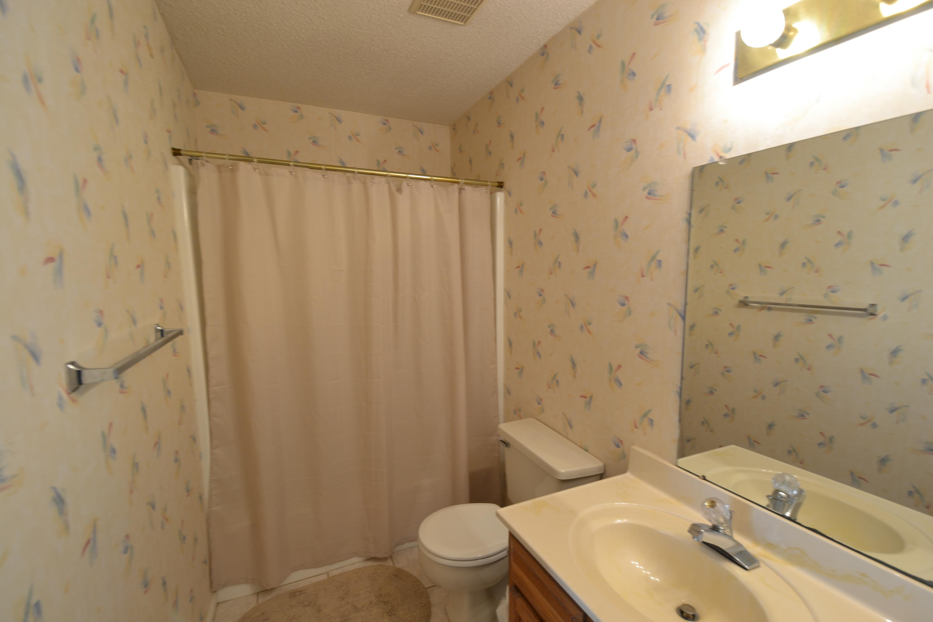 241 Ellis Road, Unit 29 Miramar Beach, FL 32550 - Photo 13 of 19 a bathroom with a sink a toilet and shower curtain