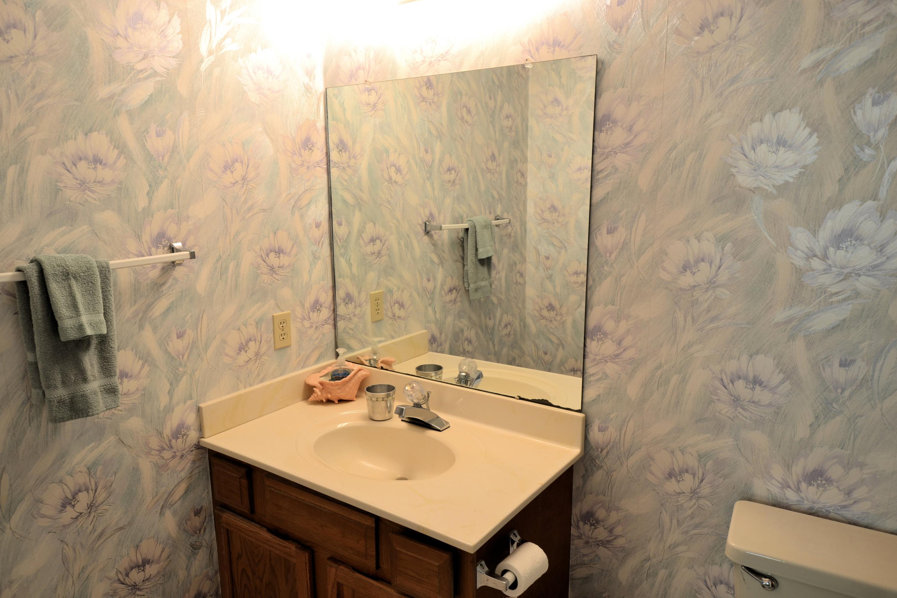 241 Ellis Road, Unit 29 Miramar Beach, FL 32550 - Photo 16 of 19 a bathroom with a sink a mirror and a shower