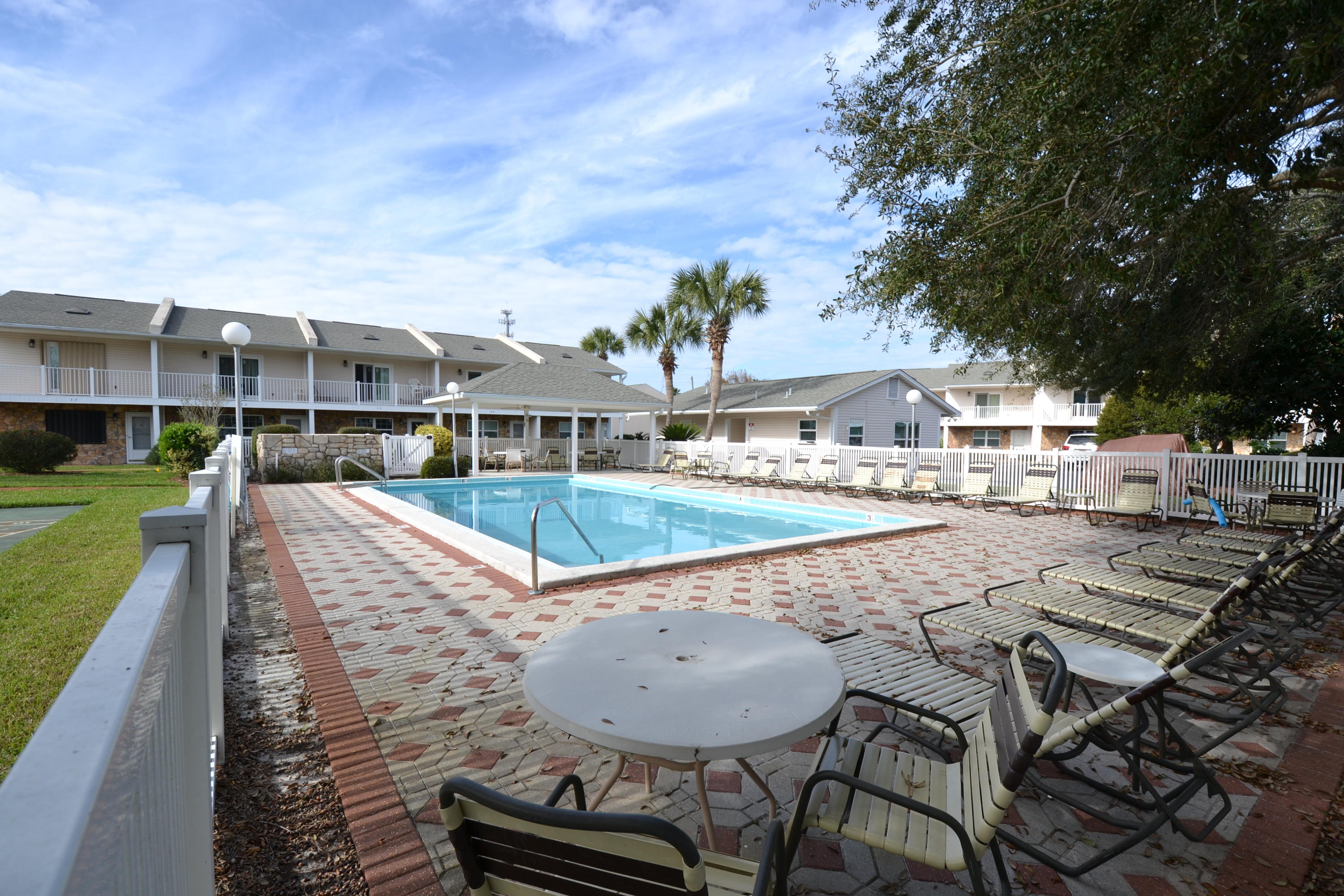 241 Ellis Road, Unit 29 Miramar Beach, FL 32550 - Photo 19 of 19 a view of a house with backyard porch and patio