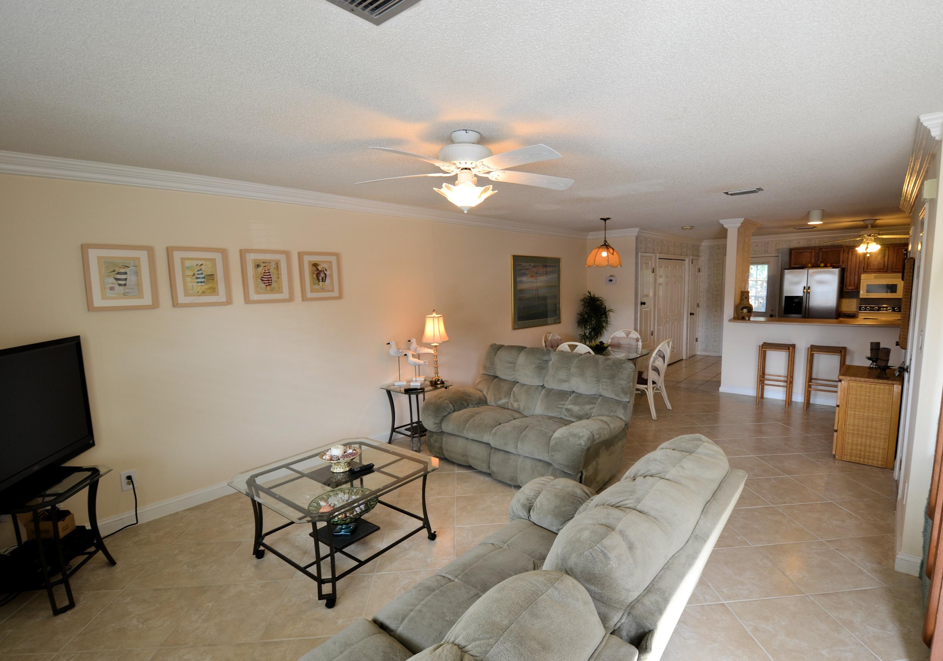 241 Ellis Road, Unit 29 Miramar Beach, FL 32550 - Photo 2 of 19 a living room with furniture kitchen view and a chandelier