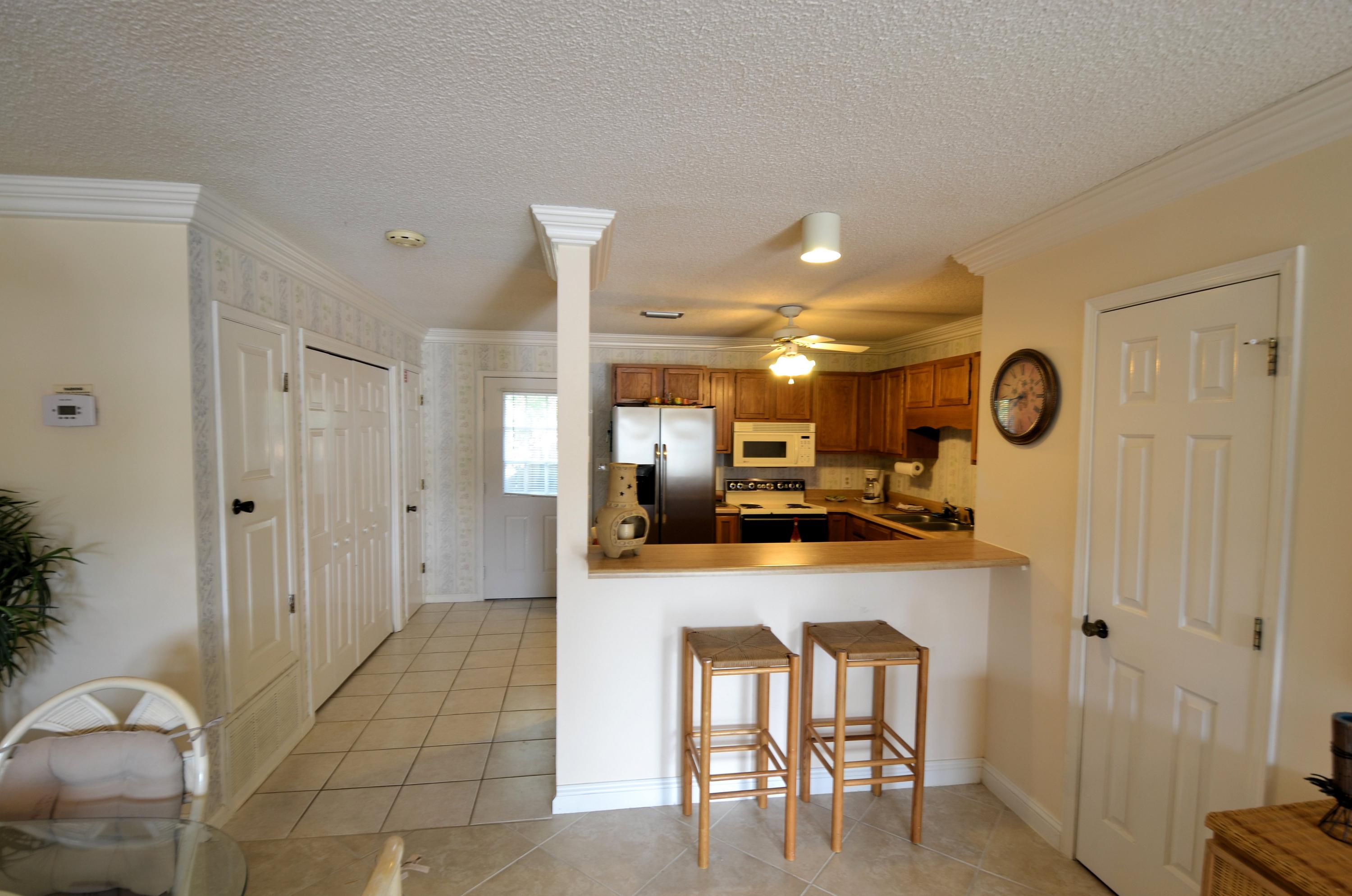 241 Ellis Road, Unit 29 Miramar Beach, FL 32550 - Photo 3 of 19 a large kitchen with a table and chairs