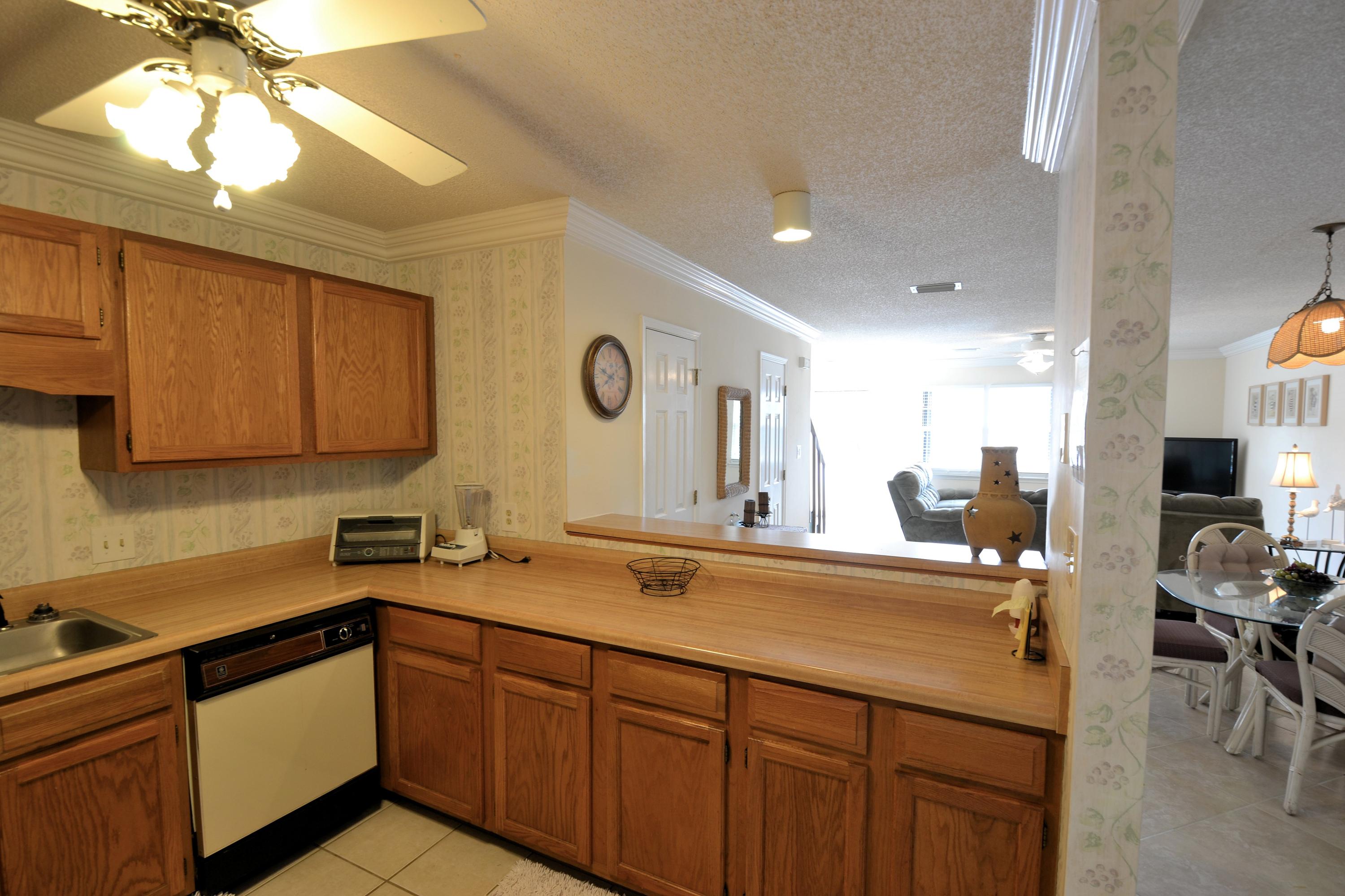 241 Ellis Road, Unit 29 Miramar Beach, FL 32550 - Photo 8 of 19 a kitchen with a sink cabinets and window