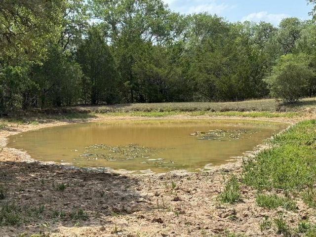 a view of a swimming pool and trees