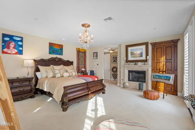 a spacious bedroom with a bed and a fireplace