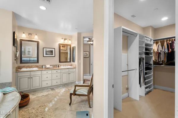 a large white room with mirror and furniture