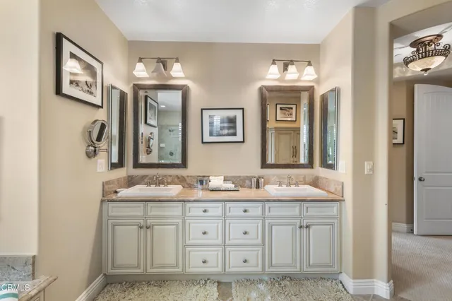 a bathroom with double sink and a mirror