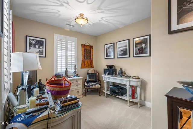 a living room with furniture a window and a fireplace