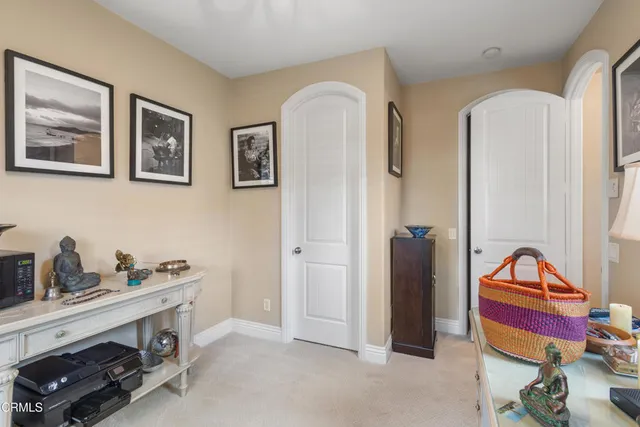 a hallway with windows and chandelier