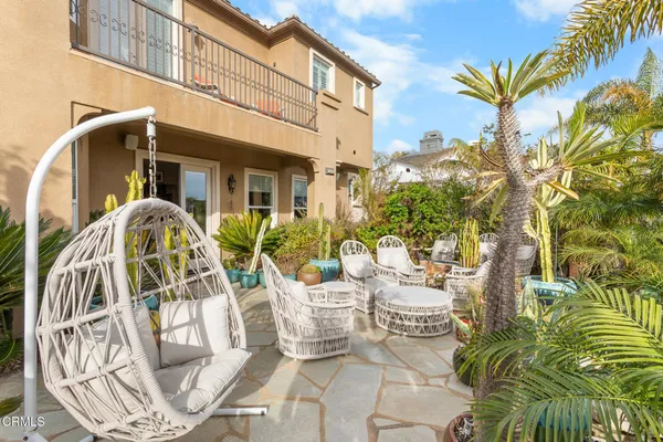 a view of a chairs and table in patio