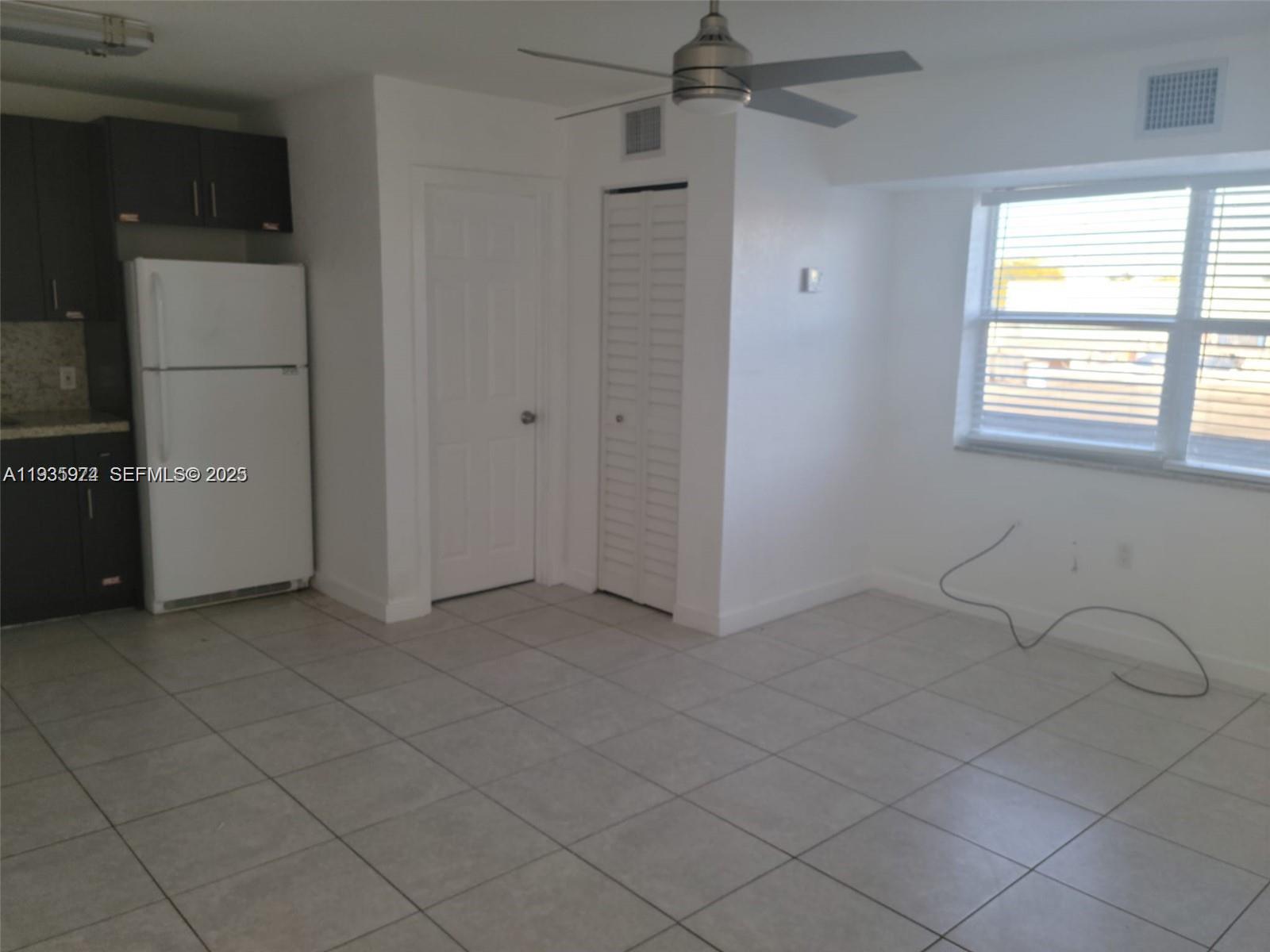 5655 Johnson Street, Unit 2 Hollywood, FL 33021 - Photo 8 of 8 an empty room with windows