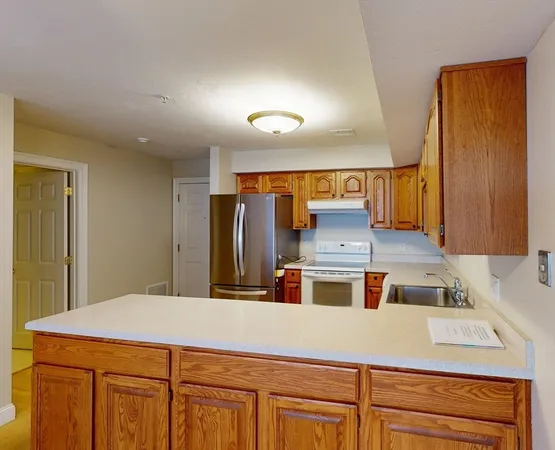a kitchen with cabinets and window