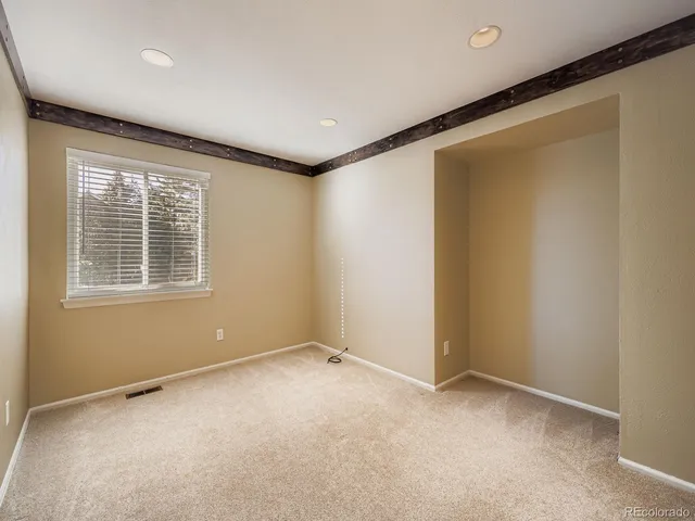 a view of an empty room with a window