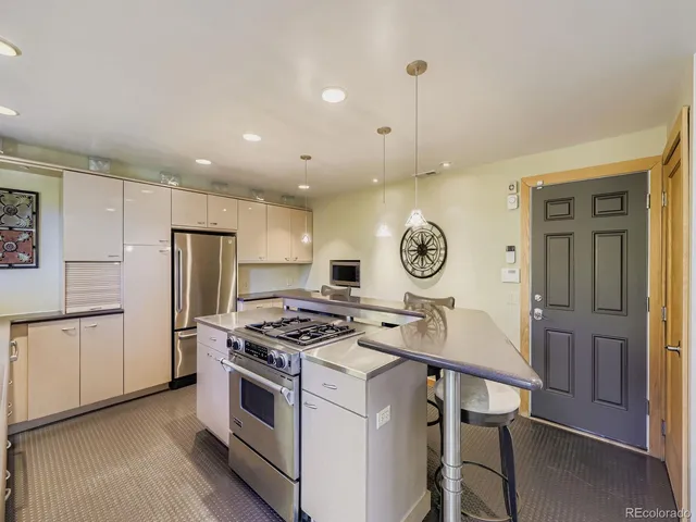 a kitchen with stainless steel appliances granite countertop a stove and a refrigerator