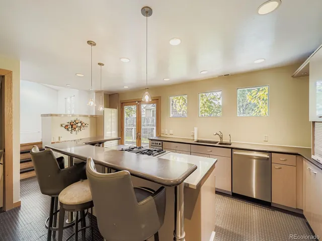 a large kitchen with a table and chairs
