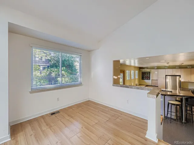 a view of a kitchen with furniture and wooden floor
