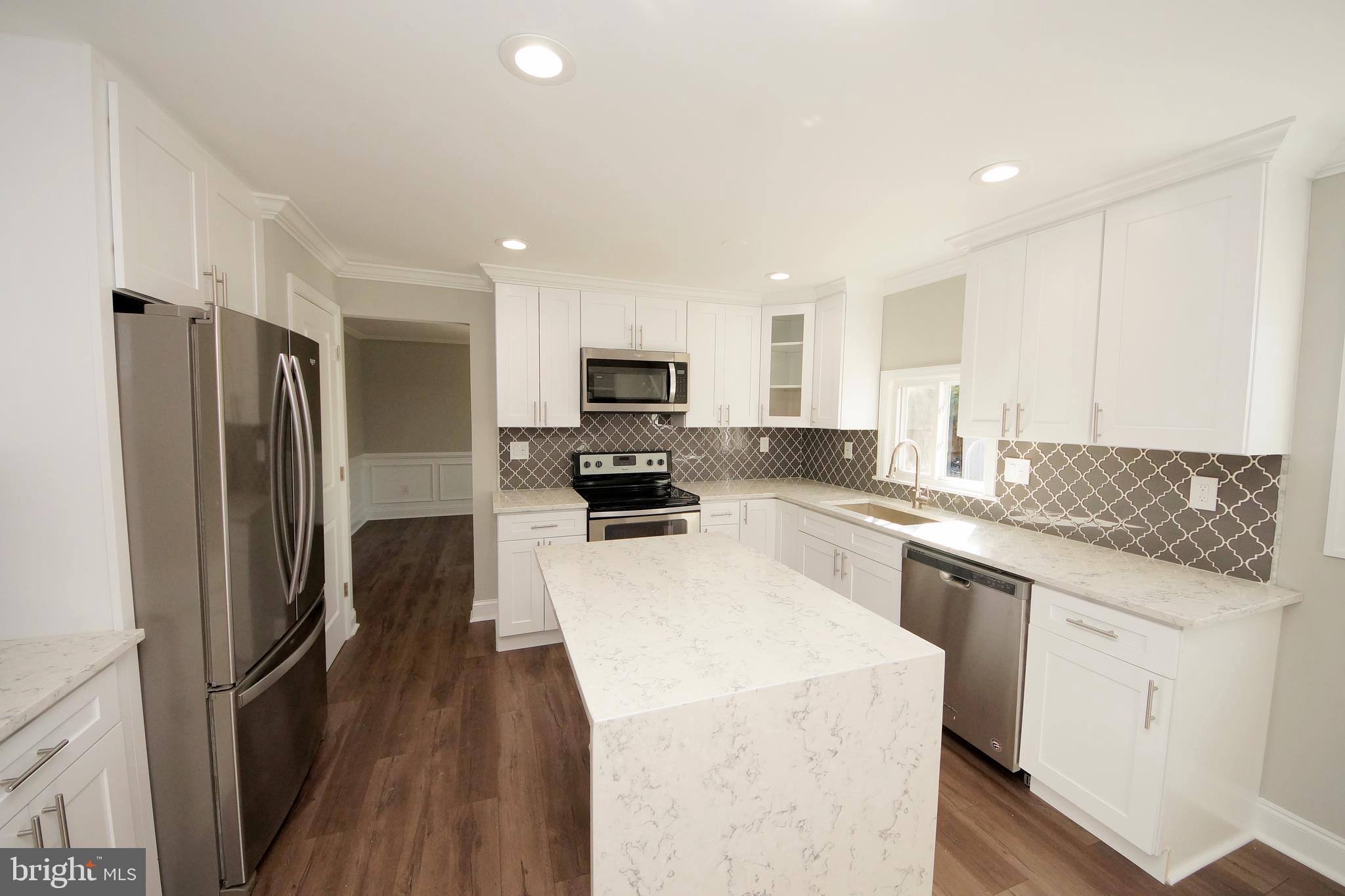 109 Coopers Kill Road Delran, NJ 08075 - Photo 15 of 35 a kitchen with a sink a refrigerator a microwave and cabinets