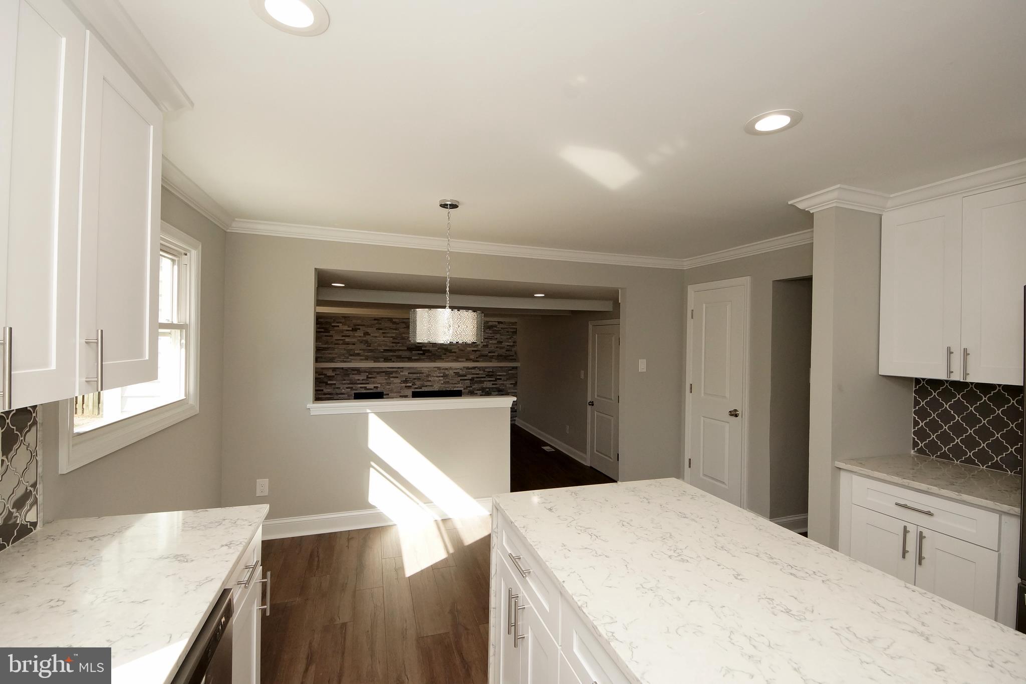 109 Coopers Kill Road Delran, NJ 08075 - Photo 19 of 35 a kitchen with stainless steel appliances kitchen island granite countertop a refrigerator a sink a stove and white cabinets