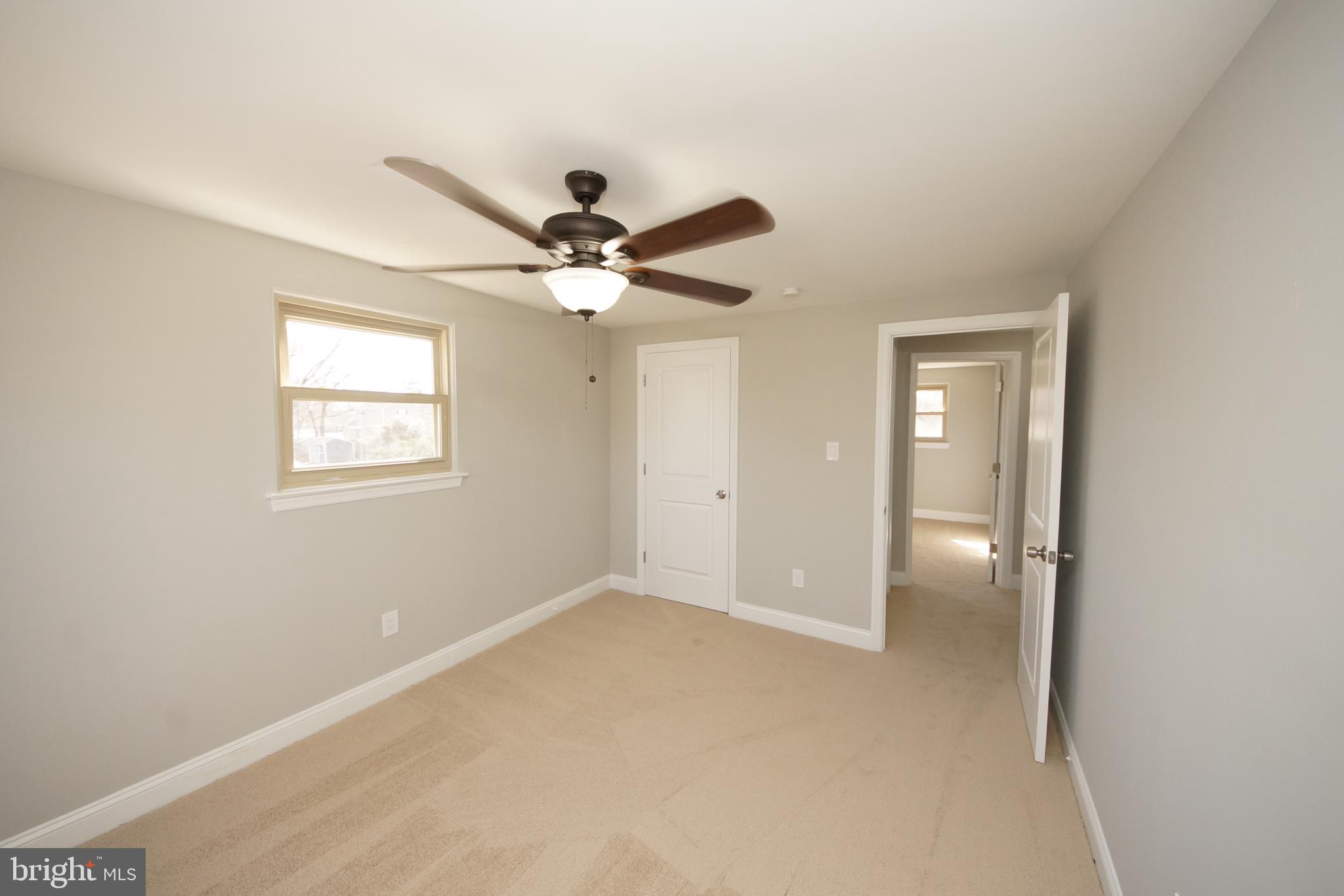 109 Coopers Kill Road Delran, NJ 08075 - Photo 22 of 35 an empty room with a ceiling fan and a window