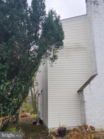 a view of a white house with a tree