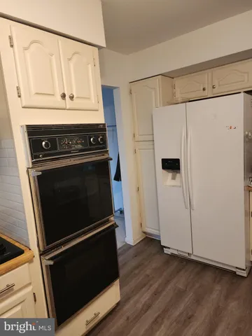 a stove top oven sitting inside of a kitchen