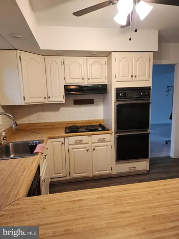 a kitchen with stainless steel appliances granite countertop a stove and a microwave