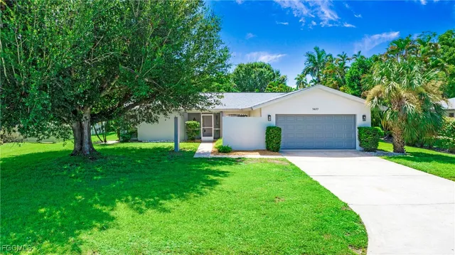 a front view of house with yard and green space