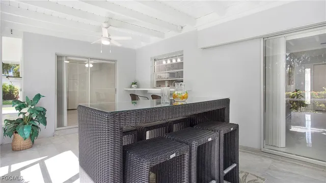 a hallway with a table and chairs