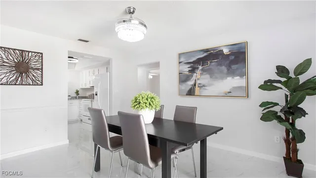 a view of a dining room with furniture and a potted plant