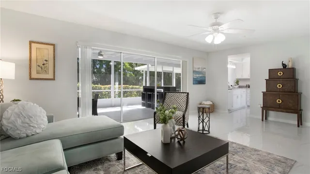 a living room with furniture and a dining table with garden view
