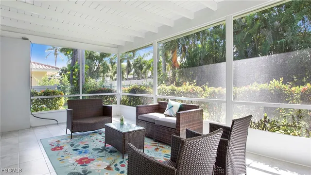 a living room with furniture and a floor to ceiling window