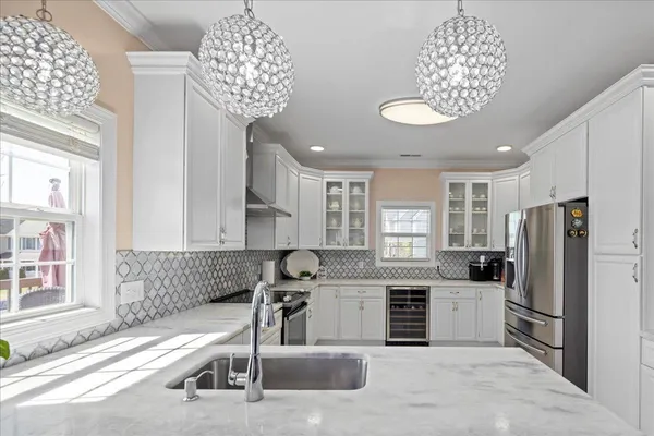 a kitchen with white cabinets and white appliances