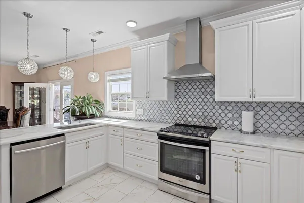 a kitchen with stainless steel appliances a refrigerator stove and cabinets