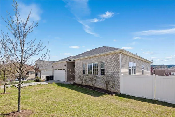 a view of a house with a backyard