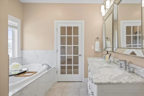 a bath tub sitting in a bathroom next to a window