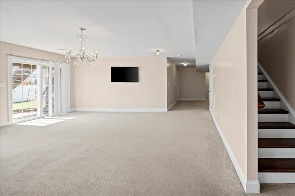 a bedroom with a bed desk and a window