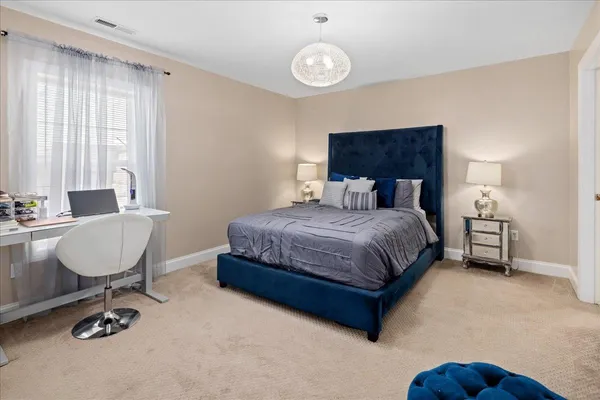 a bedroom with a bed and a couch