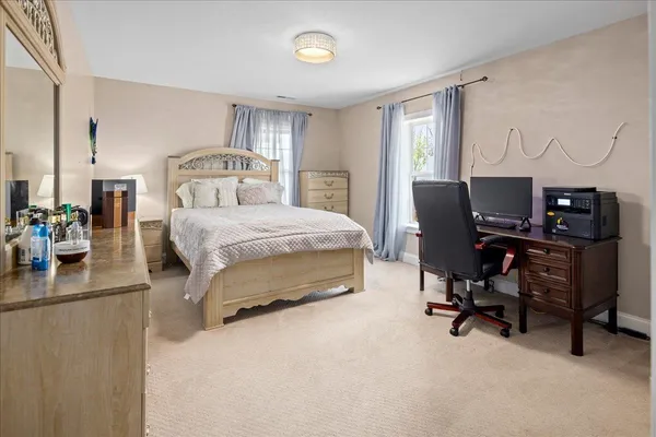 a bedroom with a bed and a couch