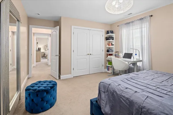 a bedroom with a large bed and a window