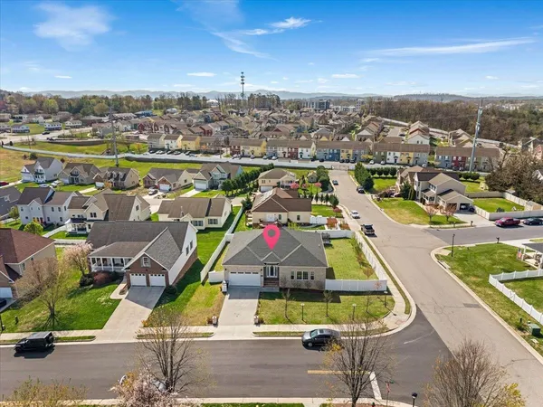 an aerial view of residential houses with outdoor space and swimming pool