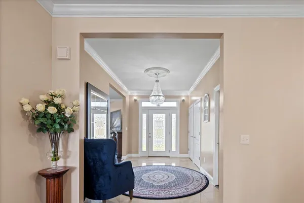 a dining room with furniture and a chandelier