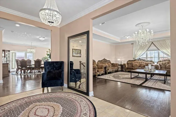 a living room with furniture and a chandelier